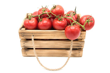 Wooden vintage box with organic ripe tomatoes isolated on a white background.