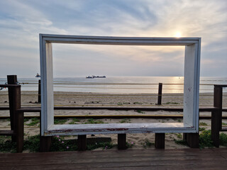 
It is a sky wooden picture frame with the sea in the background.