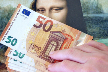 A lot of euro money against the background of an old painting Mona Liza La Gioconda from Leonardo...