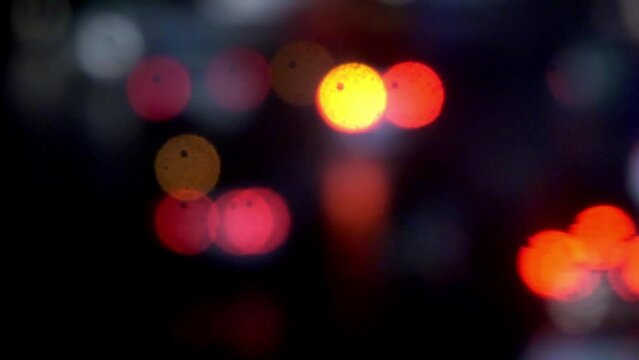 Headlights of moving cars and city lights in large bokeh,Blurring background car lights.Blured Night Traffic Car Lights on Busy Street bangladesh. Beautiful Bokeh Background. 4K.