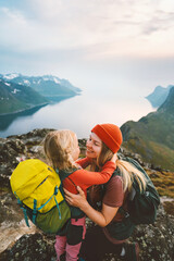 Family time Mother hiking with daughter in mountains travel in Norway together active healthy...