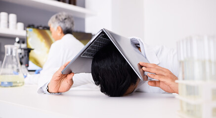 Laptop, stress and science with a man in a laboratory for problem solving a research or innovation...
