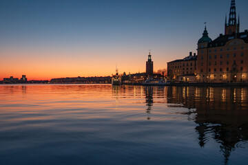 Dusk over the lake in central Stockholm, with the skyline visible, the town hall and parts of Riddarholmen's old buildings. Copy space