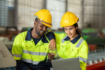 Factory apprenticeship. Man mentor teaching Female employees trainee operating machine looking monitors and check Production process machinery. foreman explaining woman engineer control machine .