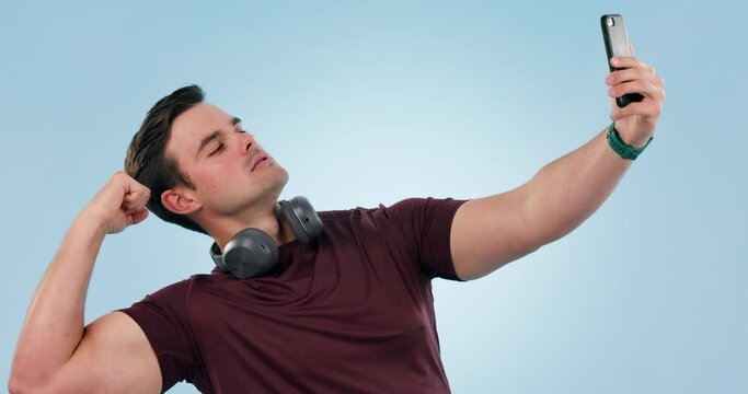 Man, fitness and flexing for selfie in studio with bodybuilder muscle, exercise and pride. Happy person with strong bicep for social media, profile picture or influencer post on blue background