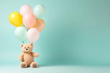 Foto op Plexiglas Beige fluffy bear kid toy with birthday balloon bunch in light pink yellow blue colours on minimal pastel background. Happy party celebration concept © Cherstva