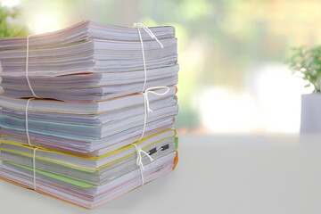 Pile or heap of financial business document paperwork stack on office desk concept of workload overtime or workplace paperless copy