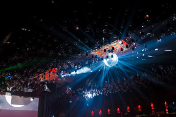 The atmosphere of the nightclub, the interior, the ceiling with a disco, a shiny glare, a ball and...