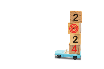 Model car with wooden blocks on top. The concept of traveling towards the goal. Countdown to 2024 with target board on stacked wooden cubes for preparing and starting new business goal strategy ideas.
