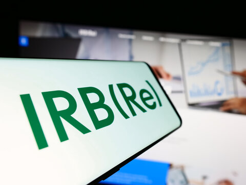 Stuttgart, Germany - 09-11-2023: Mobile phone with logo of Brazilian reinsurance company IRB Brasil RE on screen in front of business website. Focus on center of phone display.