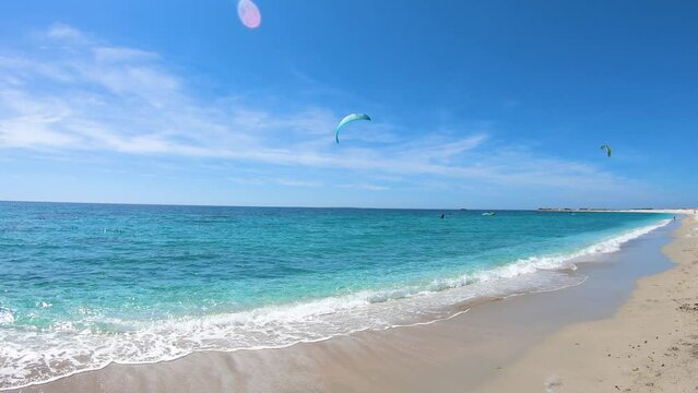 Kite surfing in Mari Ermi beach on a sunny day. Sardinia, Italy