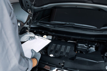 Close-up hand auto mechanic using the wrench to repairing car engine problem. Concepts of check and inspection car care maintenance and servicing.