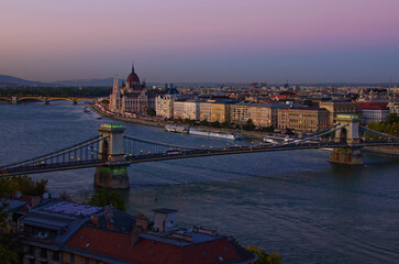 Aerial sunset cityscape view of Budapest. Chain Bridge over Danube river and Parliament Building in the background. Travel and tourism concept