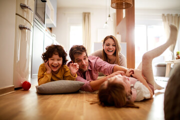 Young happy Caucasian family being playful and having fun at home