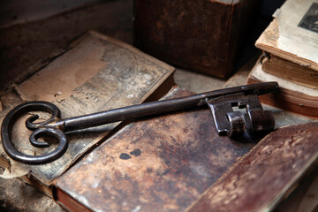 vintage old rusty key on old books - 648182461