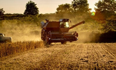 Old combine harvester working on a field