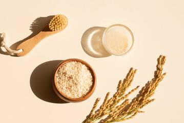 Homemade healthy rice water - natural toner for skin and hair care. Eco cosmetics. Flat lay composition with rice water and ears of rice. Natural cosmetics product background. Earth tones