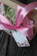 Homemade marshmallows in a paper gift box. Zephyr flowers. The box is tied with a ribbon tied into...