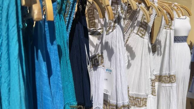street market selling Greek dresses of different colors on island of Corfu