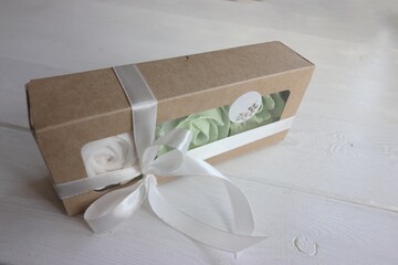 Homemade marshmallows in a paper gift boxes. Zephyr flowers. The boxes is tied with a ribbon tied into a bow. Label for the text.