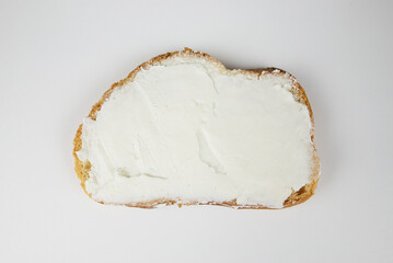 white bread with cream cheese on a white background.