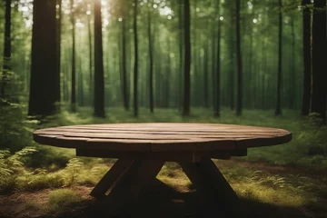 Rolgordijnen A wooden table stands in a green forest, surrounded by tall trees blurred background © FrameFinesse