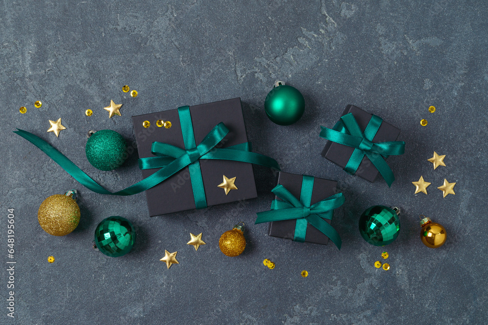 Wall mural christmas holiday concept with black gift boxes, green ribbons and decorations on dark background. t