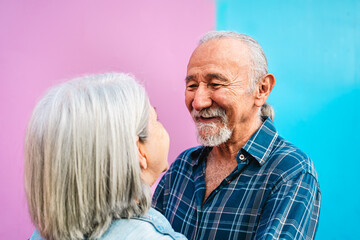 Happy senior couple having tender moments outdoor - Elderly people and love relationship concept