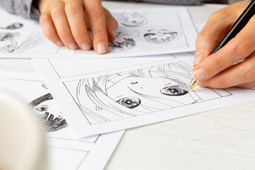 An artist draws a storyboard of an anime comics book. Manga style.	 - 648201445
