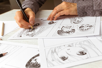 An artist draws a storyboard of an anime comics book. Manga style.	 - 648201495