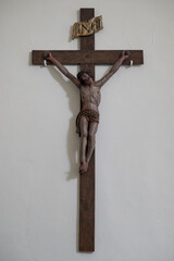 Carved cross with Jesus on the wall.