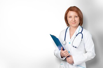 Female doctor with a stethoscope posing on background