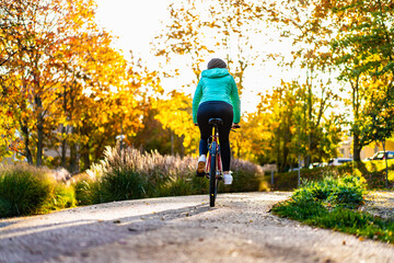 Woman riding bicycle in city park
