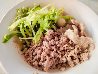 Dried spicy noodles with chopped cabbage, minced pork and meatballs - street food, Asian food style