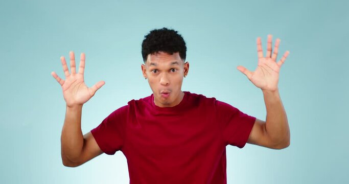 Face, wow and mind blown with the reaction of a man in studio on a blue background looking shocked at news. Portrait, alarm and surprise with a young person hearing a secret, announcement or gossip