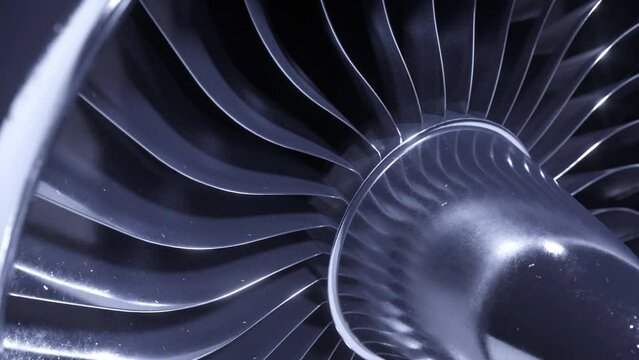 A large jet engine turbine full screen, with a lot of silver blades interconnected to each other and a central silver dome. Energy concept