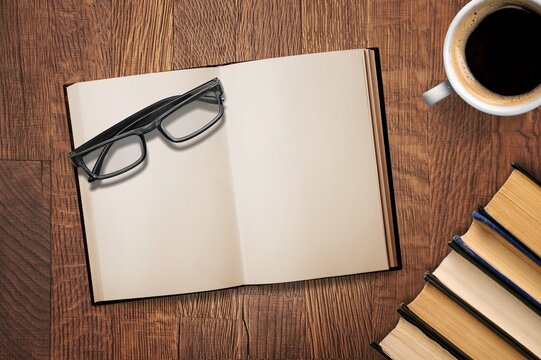 open retro book with reading glasses