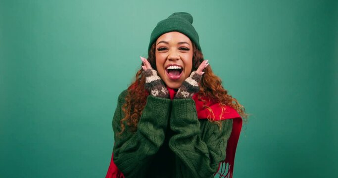 Excited young woman squeals with hands under chin, Cozy winter Christmas studio