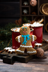 winter treats, gingerbread man cookies and hot chocolate on wooden table