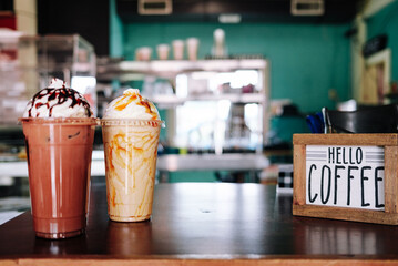 Drinks at a coffee shop with a hello coffee sign