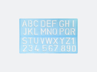 Light blue alphabet stencil lettering PVC plastic ruler template isolated on white background