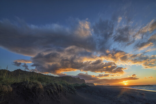 A Beautiful Sunrise Occurs Over The Beach And Town Of Vik Along The South Coast Of Iceland; Vik, Iceland
