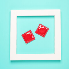 Condoms in white square frame. Aesthetic minimal still life. Concept photo. Top view