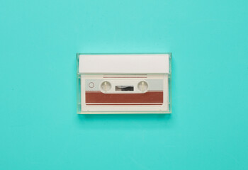 Fototapeta premium Retro 80s audio cassette in box on blue background. Music concept, vintage technology