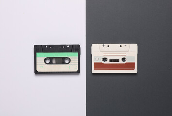 Fototapeta premium Retro 80s audio cassettes on white black background. Music concept, vintage technology. Top view