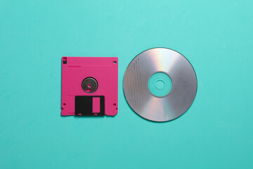 Floppy disk and cd on a blue background. top view