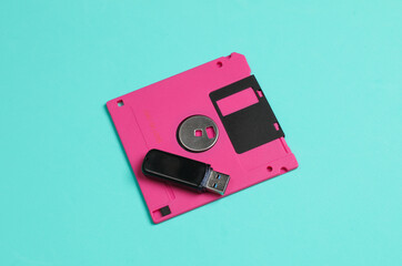 New and old technologies. Retro floppy disk and modern usb flash drive on blue background.