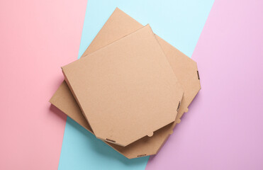 Craft cardboard pizza boxes on pastel background. Top view