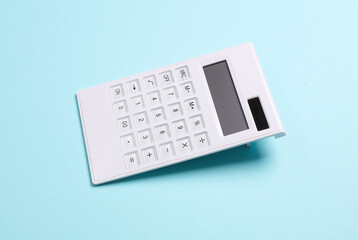 White calculator on a blue background