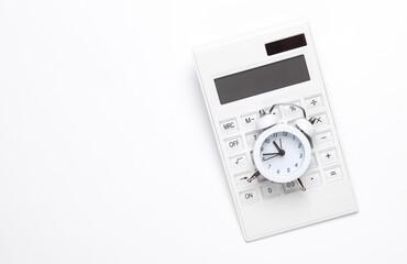 Calculator with an alarm clock on a white background. Time is money. Business concept